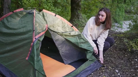 4K 10 bit. Setup a tent in campground. Active young woman on a hike. Happy Stock Footage 162236363