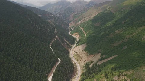 4K 10-bit top-down drone shot flying over a winding mountain road cutting 스톡 동영상 342267048