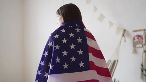 4k 10 bit. US flag. A proud woman stands with the national flag and looks into Stock Footage 153042222