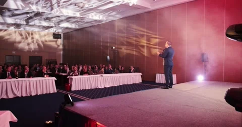 4k 120fps shot of a man standing on a podium stage in front of many people in su Stock Footage 242036431