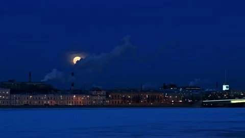 4K 16:9 winter night cityscape. Giant full in clouds Stock Footage 168976848