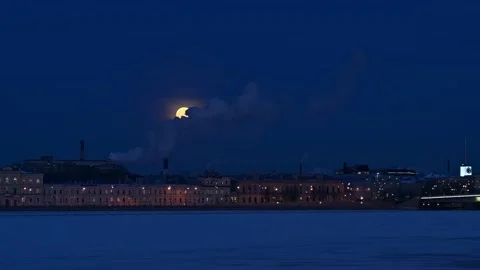 4K 16:9 winter night cityscape. Giant full in clouds Stock Footage 168976919