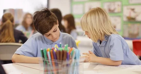 4K 2 little boys drawing together in elementary school classroom Stock Footage 74262001