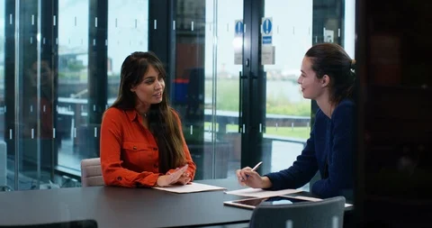4K 2 Young female executives in a meeting in modern glass office Stock Footage 118736357