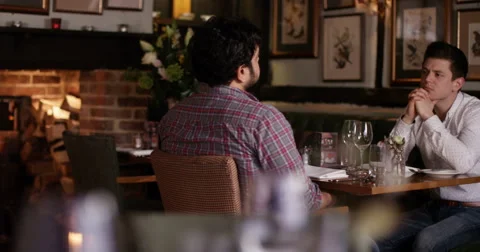 4K 2 Young men chatting over drinks in quiet bar &amp; restaurant Stock Footage 62923781