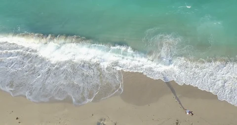 4k 24 Aerial looking down on waves crashing against beach shoreline Stock Footage 86093485