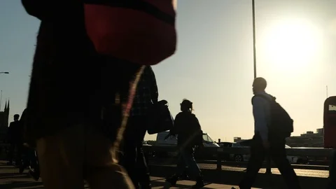 4k 25fps low angle shot of people walking past sunset on bridge Stock Footage 120171043