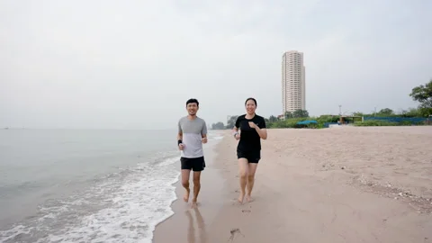 4K 25fps Slow Motion, Young Asians jogging by the sea in the morning, Stock Footage 172160732