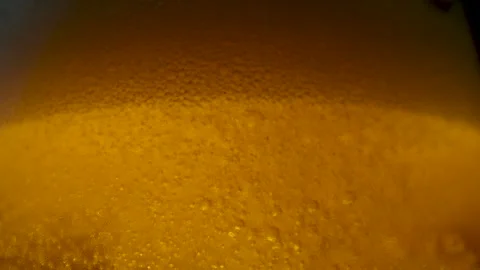 4K 29.97fps Macro Shot: Beer Pouring into Glass, Bubbles and Froth Settling Stock Footage 321684876