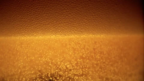 4K 29.97fps Macro Shot: Beer Carbonation Settling with Foam Stock Footage 321685026