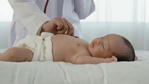4K 50fps, Close-up of a two-month-old newborn baby lying on a white bed Stock Footage 171196904