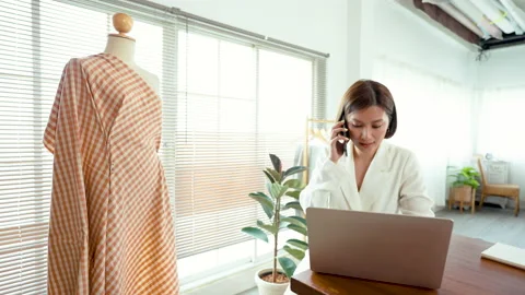 4K 50fps, Clothing store owners are taking orders over the phone and online Stock Footage 182978053