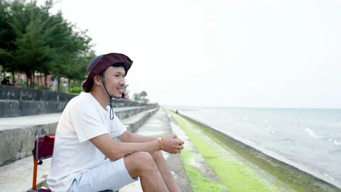 4K 50fps, A nice-looking Asian guy wearing his favorite hat, Stock Footage 172560020