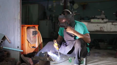4K 50fps, A senior mechanic is using a welding machine, welding the iron Stock Footage 192325355