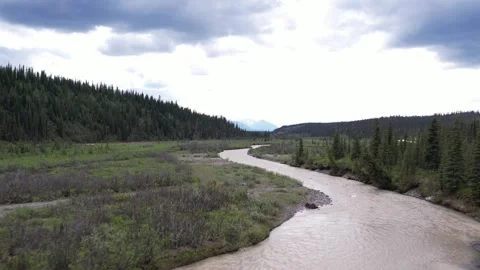 4K, 59.94fps. Very low-altitude aerial over a gravel bar and small river split Video stock 340488301