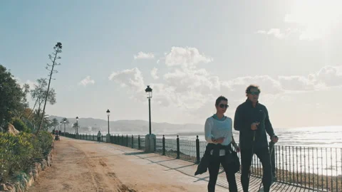 4K 60 fps Couple walking on promenade in Marbella, Spain, healthy lifestyle Stock Footage 138521236