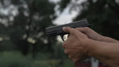 4k 60 fps Slow Mo Man Fires 44mm Hand Gun Shooting Tight Shot Target Stock Footage 307131815