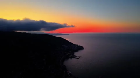 4K 60FPS Cinematic Sunset Over Misty Hills and Red Sea Horizon Drone Shot Stock Footage 334306667