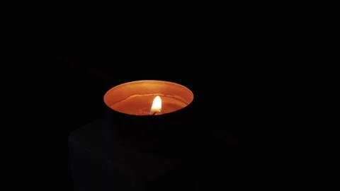 4K 60FPS Close-Up of a Single Tealight Candle Burning in the Dark Stock Footage 335963720