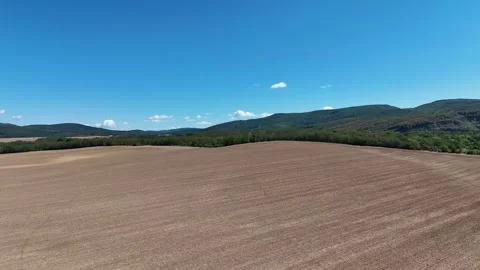 4K 60fps Drone Flyover: Agricultural Field and Mountain Horizon Stockbeeldmateriaal 343247789