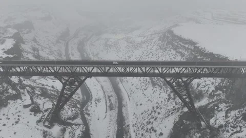 4K 60fps Drone perspective of a snowy highway interchange and bridge. Video stock 327984448