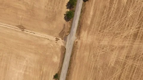 4K 60fps Drone Top-Down Spiral Descent: Rotating Left Over Country Road Stock Footage 340028875