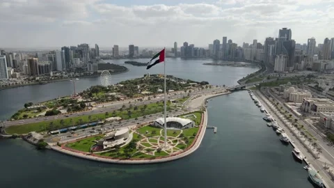 4K-60FPS - Drone view of the Flag of the UAE waving in the air on a cloudy Stock Footage 167940835