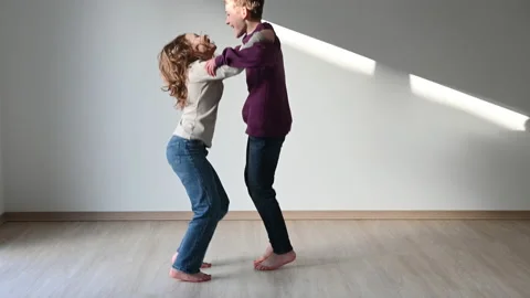 4K 60fps funny video of two siblings jumping and having fun together at home Stock Footage 170155371