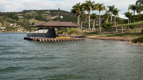 4K 60fps - Lakeside Dock with Covered Boat on Calima Lake Colombia, Tropical Mou Stock Footage 341298093