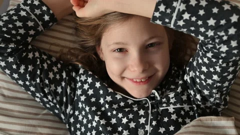 4K 60fps of portrait of cute smiling teen child girl waking up in the morning Stock Footage 169906254