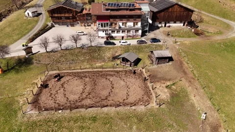 4K 60fps Static Drone: People Training Horses at Alpine Farm, Saalbach Stock Footage 332664962