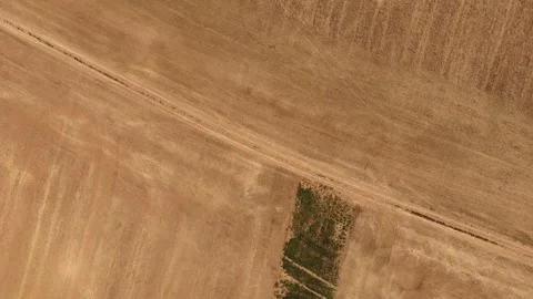 4K 60fps Top-Down Spiral Descent: Rotating Left Over Agricultural Field and Road Stock Footage 340188069