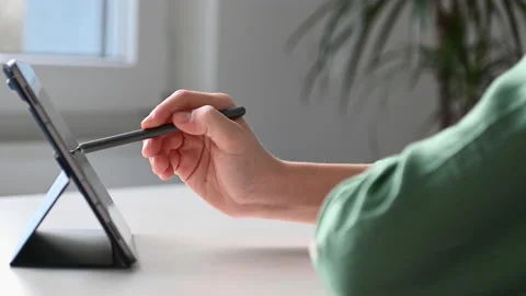 4K 60fps video of child tapping tablet doing homework at online course Stock Footage 168865254