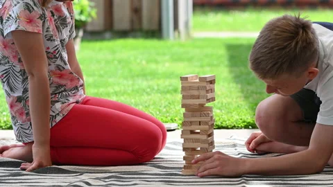 4K 60fps video of two happy children playing with wooden blocks. Having fun t Stock Footage 161114246