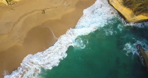 4k 90 degrees aerial view of the waves at the beach of London Arch in Australia. Stock Footage 131214009