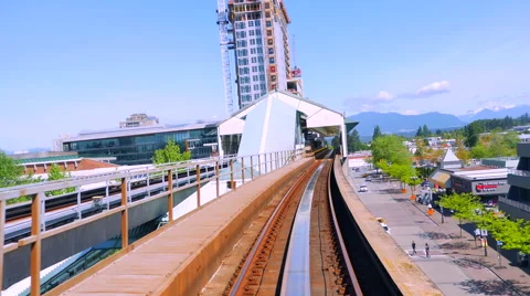 4K Above Ground Train Arrives at Station Platform Stock Footage 65583723