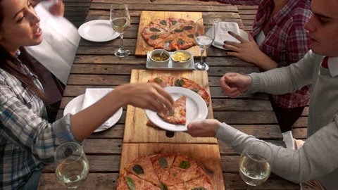 4k above video of multicultural group of young friends enjoying a meal, aerial v Stock Footage 201096745