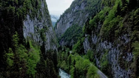 4k Above view of road running among mountains and river in open air irrl. Stock Footage 219895399
