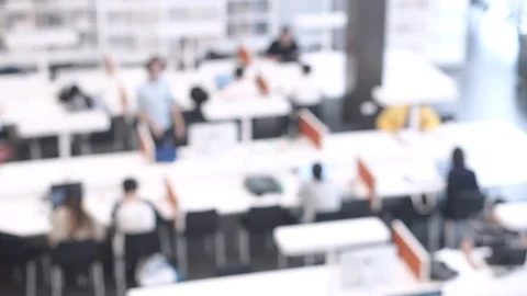 4K. Abstract blurred public library interior with people on modern desk Stock Footage 91074087