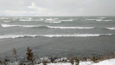 4K: Active weather winter snow storm at lake with high speed wind and high waves Stock Footage 110057025