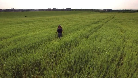 4K Aerial above Fields, Hipster Girl Walking to Camera Stock Footage 76880653