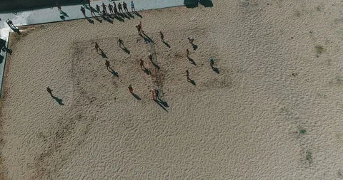 4K Aerial above Large Group Of Happy Young Friends Playing Beach Volleyball Stock Footage 101263231
