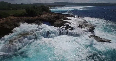 4K AERIAL BIG WAVES SPLASH AGAINST ROCK CLIFFS Stock Footage 60230559