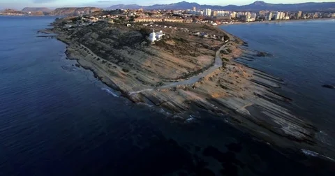 4K Aerial cape view from drone at sunrise with lighthouse Stock Footage 76384789