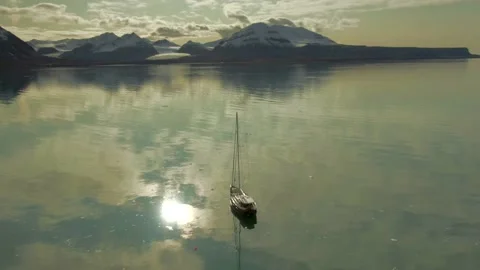 4k Aerial circling drone over sailboat in Svalbard Stock Footage
