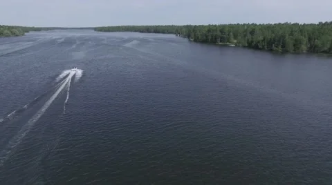 4k aerial descending down over boats wake Stock Footage 64987308