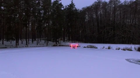  4K Aerial. Drone with blinking fires in  evening winter wood  Stockbeeldmateriaal 70800399
