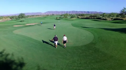 4K Aerial Drone Desert Golf Course Flyover 4 Men Walking to Green Stock Footage