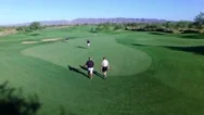4K Aerial Drone Desert Golf Course Flyover 4 Men Walking To Green Stock Footage