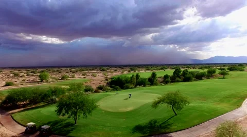 4K Aerial Drone Desert Golf Course Crane Down Reveal Dust Storm Golfers Putting Stock Footage